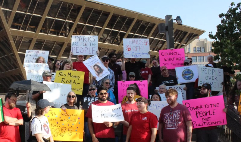protesters hold signs in front of tempe city hall