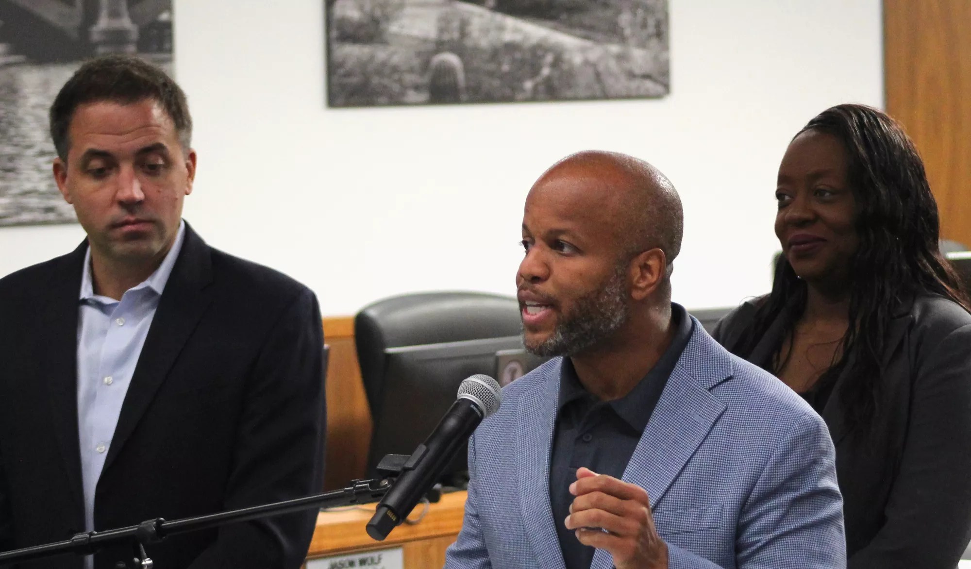 corey woods speaks at a microphone