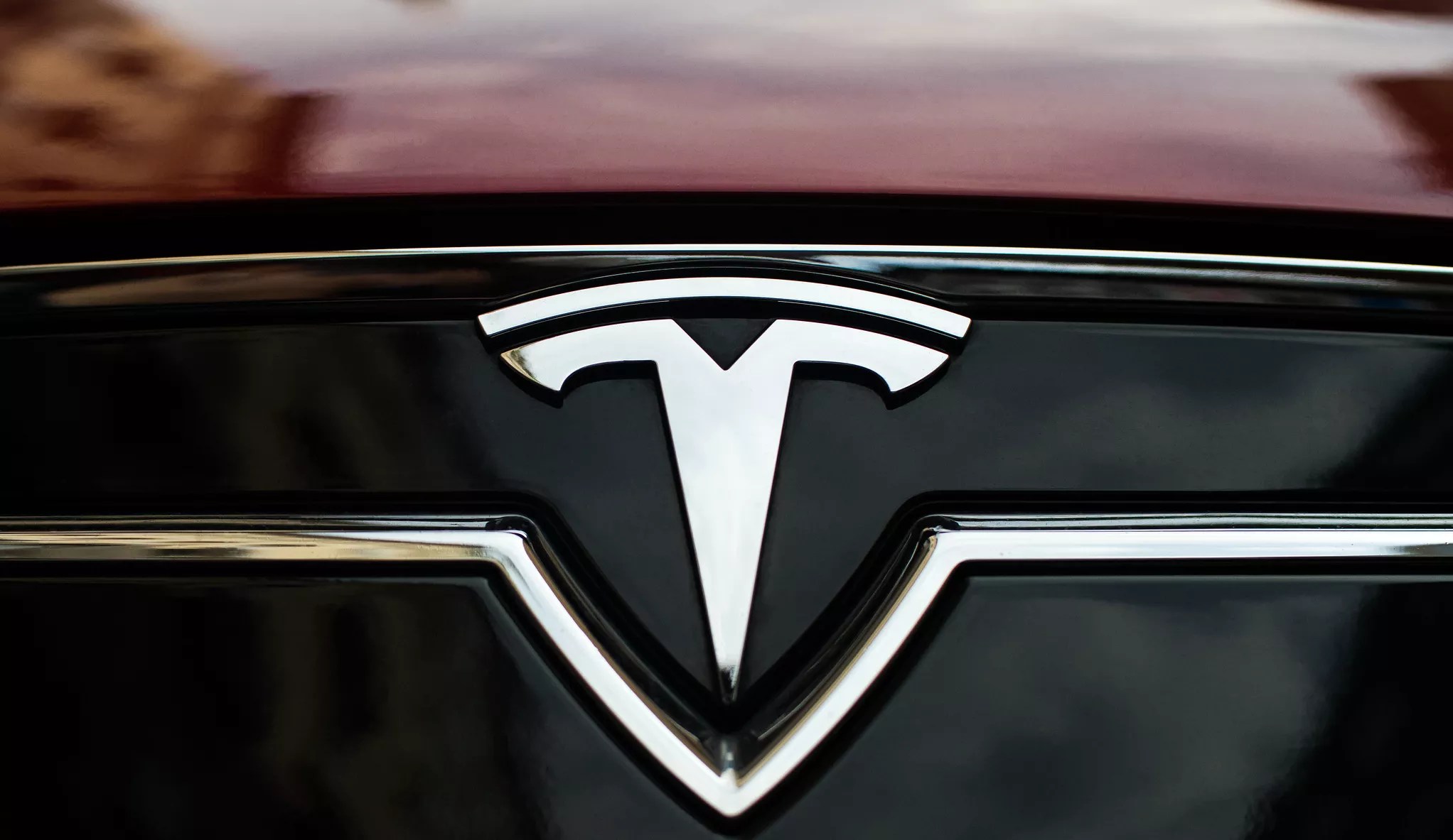 a tesla logo on the front of a car