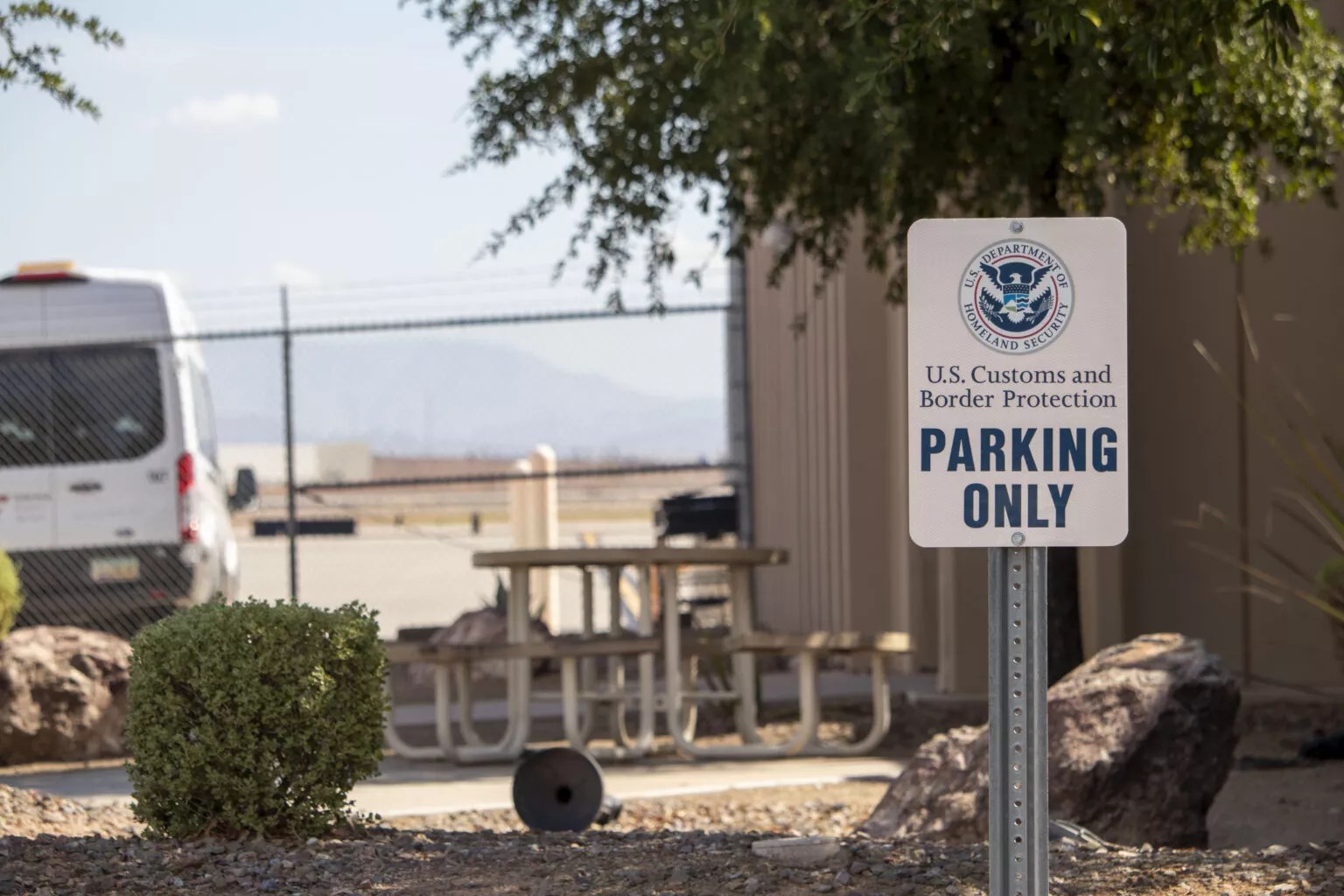 an customs and border protection parking sign in front of a building