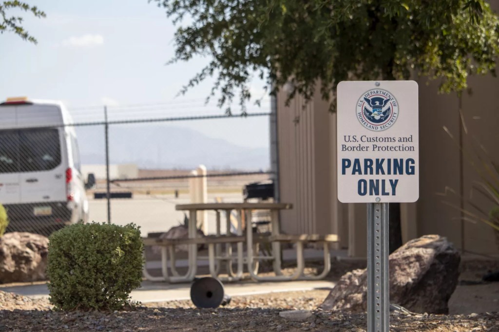 an customs and border protection parking sign in front of a building