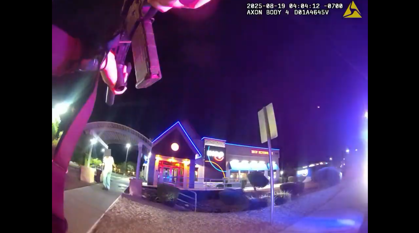 body-cam footage of a police officer pointing a gun at a man at night