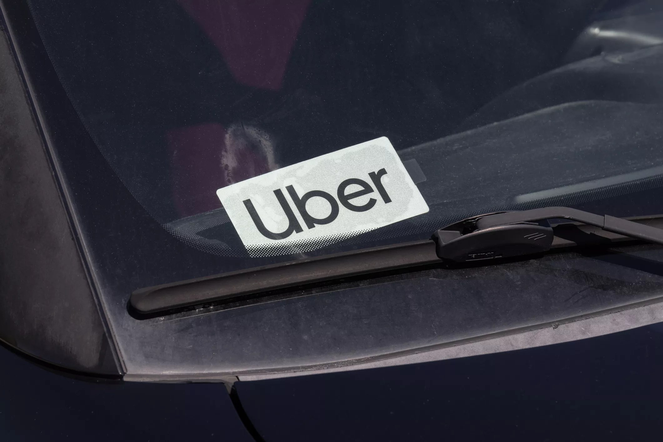 an uber logo in the windshield of a car